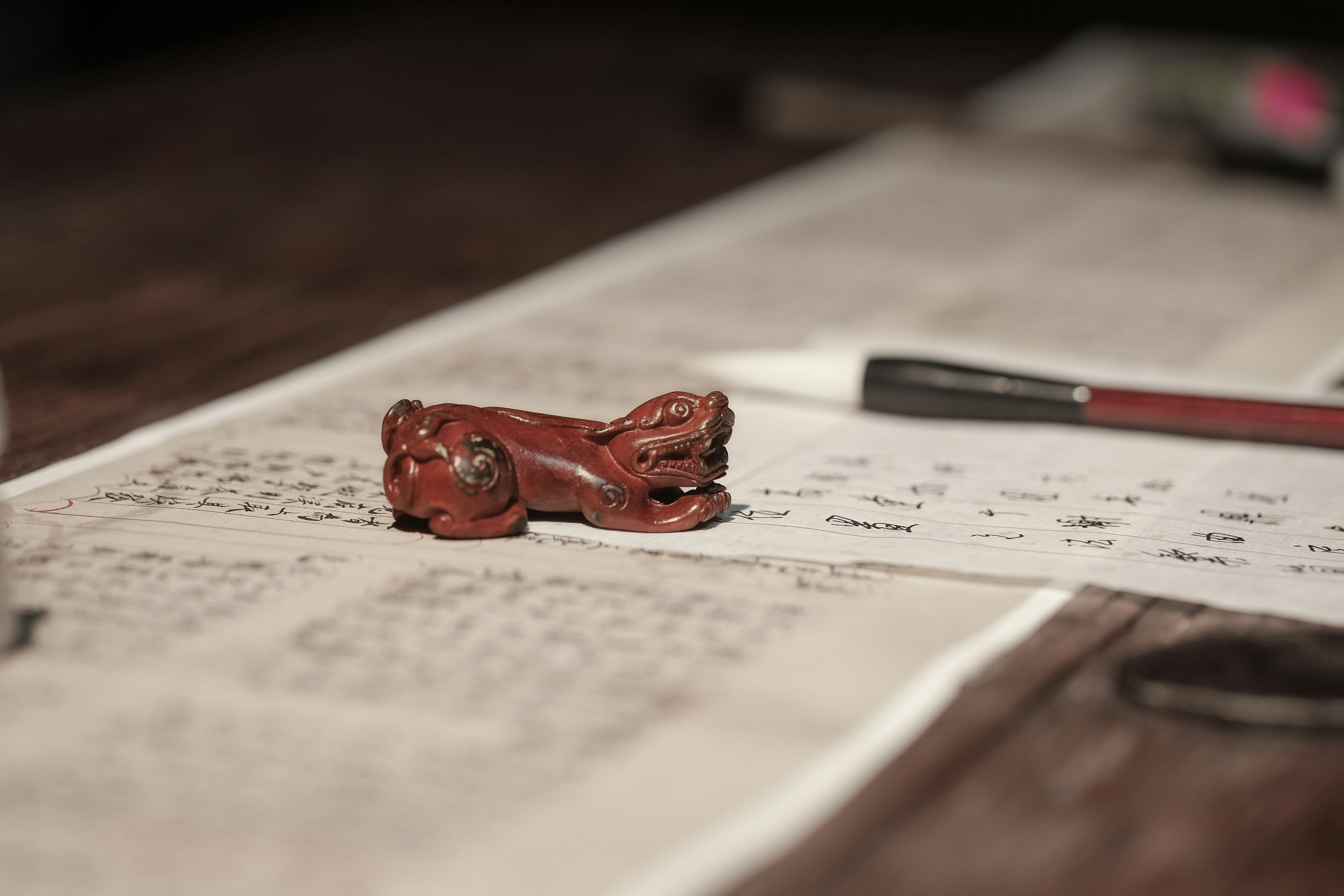 red wooden elephant figurine on white printer paper